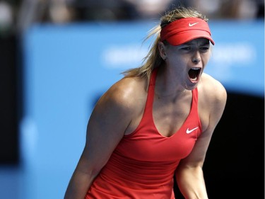 Maria Sharapova of Russia celebrates a point won against Eugenie Bouchard of Canada during their quarterfinal match at the Australian Open tennis championship in Melbourne, Australia, Tuesday, Jan. 27, 2015.