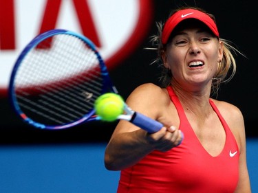 Maria Sharapova of Russia makes a backhand return to Eugenie Bouchard of Canada during their quarterfinal match at the Australian Open tennis championship in Melbourne, Australia, Tuesday, Jan. 27, 2015.