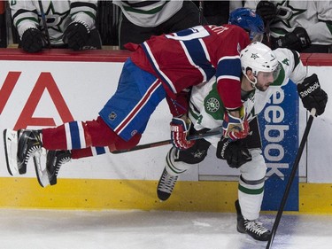 Montreal Canadiens' Max Pacioretty leans on Dallas Stars' Jason Demers during second period NHL hockey action Tuesday, January 27, 2015 in Montreal.