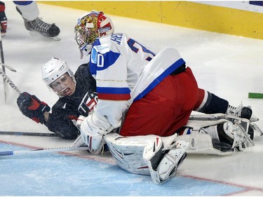 USA's Miles Wood slides into Russia's goaltender Igor Shestyorkin during third period quarter-final hockey action at the IIHF World Junior Championship Friday, January 2, 2015 in Montreal. Russia won the game 3-2 to advance to the semifinals.