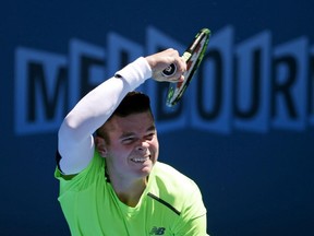 Milos Raonic of Canada serves to Benjamin Becker of Germany during their third round match at the Australian Open tennis championship in Melbourne, Australia, Saturday, Jan. 24, 2015.