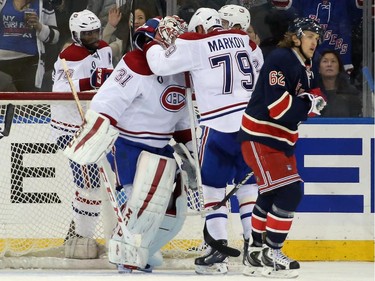 Carey Price (#31) and Andrei Markov( #79) of the Montreal Canadiens celebrate a 1-0 shutout over the New York Rangers at Madison Square Garden on January 29, 2015 in New York City.