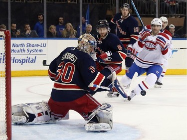 Henrik Lundqvist (#30) of the New York Rangers makes a first period save against the Montreal Canadiens at Madison Square Garden on January 29, 2015 in New York City.