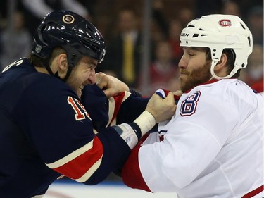 Tanner Glass (#15) of the New York Rangers and Brandon Prust (#8) of the Montreal Canadiens go toe-to-toe during the first period at Madison Square Garden on January 29, 2015 in New York City.