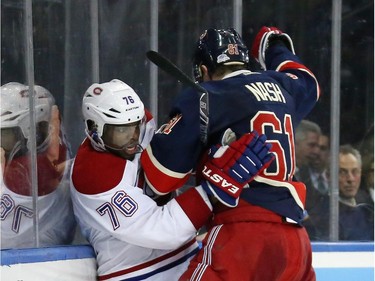 Rick Nash (#61) of the New York Rangers gets the elbow up on P.K. Subban (#76) of the Montreal Canadiens at Madison Square Garden on January 29, 2015 in New York City.