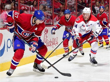 Branden Holtby #70 of the Washington Capitals watches Max Pacioretty #67 of the Montreal Canadiens in the third period during the Capitals NHL season opener at Verizon Center on October 9, 2014 in Washington, DC.