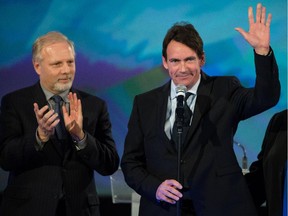 Parti Québécois MNA for Saint-Jérôme Pierre Karl Péladeau, right, waves to supporters along with MNA Jean-François Lisée, on the night of the Quebec provincial election at the PQ election night headquarters at the Westin hotel in Montreal on Monday, April 7, 2014.