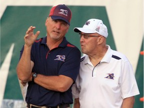 MONTREAL, QUE.: AUGUST 08, 2014 -- Montreal Alouettes coaching consultants Turk Schonert, left, and Don Matthews talk on the sidelines during Canadian Football League game against the Edmonton Eskimos in Montreal Friday August 08, 2014.   (John Mahoney  / THE GAZETTE) ORG XMIT: 50596-9280