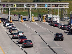 File photo: Cars and trucks line up to pay their toll fees on Highway 30 as they enter Les Cedres from the Beauharnois/Valleyfield area