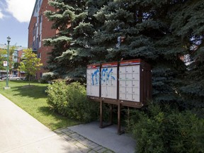 Graffiti is seen on a community mailbox in Lachine last summer. Pictures of communal mailboxes covered in mountains of snow, surrounded by icy walkways or ripped open by thieves were shown at public hearing on Tuesday.