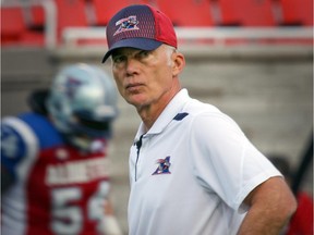 Alouettes head coach Tom Higgins watches his team warm up before game against the Ottawa Red Blacks at Montreal's Molson Stadium on Aug. 29, 2014.