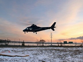 Pilot André Bibeau of Hélico Pro flying school, lands an Agusta 109 helicopter at a makeshift landing site near the Victoria Bridge in Montreal Wednesday December 11, 2013.