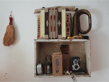 A shelf made from a wooden box hangs on the wall.