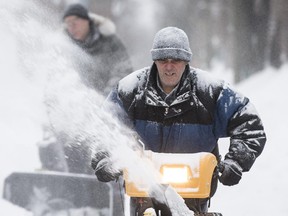 MONTREAL, QUE.: DECEMBER 22, 2013 --  Artur Vieira uses a snowblower to remove snow form an alley in the neighbourhood of Villeray during a snowstorm with mixed snow and ice pellets in Montreal on Sunday, December 22, 2013. (Dario Ayala / THE GAZETTE) ORG XMIT: 48839