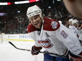 The Canadiens' Mike Komisarek smiles at a young fan during warmup before game against the Ottawa Senators at the Bell Centre on Feb. 21, 2009.