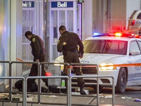 Sûreté du Québec police officers at the scene where Alain Magloire was shot and killed by a SPVM officer outside the Gare d'autocar de Montréal bus station Monday, February 3, 2014.