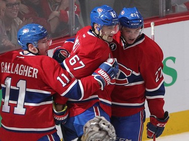 Montreal Canadiens' Max Pacioretty, centre, celebrates his unassisted goal with teammates Brendan Gallagher and Alex Galchenyuk, right, while Pittsburgh Penguins goalie Marc-Andre Fleury looks away, during first period NHL action in Montreal on Saturday January 10, 2015.