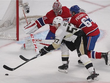 Penguins' Marcel Goc gets in close to Montreal Canadiens goalie Carey Price, while Montreal Canadiens' Max Pacioretty closes in on the play, during second period NHL action in Montreal on Saturday Jan. 10, 2015.