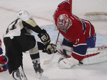 MONTREAL, QUE.: JANUARY  10, 2015 -- Pittsburgh Penguins Simon Despres, gets in close on Montreal Canadiens goalie Carey Price during first period NHL action in Montreal on Saturday January 10, 2015. (Pierre Obendrauf / MONTREAL GAZETTE)