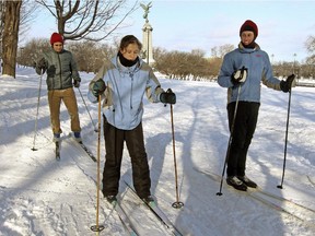 Instructor Frédéric Ménage, right, helps new Canadians Nicolas Ortiz, left, and Andrea Diaz cross-country ski for the first time on Mount Royal during  an intercultural recreation class sponsored by the Milton Park Recreational Program.