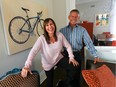 Beth Stutman and Mark Weinberg in her home: the painting of her bike is by Montreal artist Daniel Magidson. The two friends participate in fundraising cycling trips that have raised thousands of dollars to help sick and disabled children.