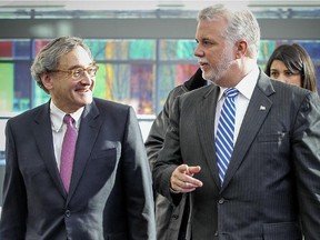 Quebec Premier Philippe Couillard, right, and Michael Sabia, President and CEO of the Caisse de depot et placement du Quebec arrive for the announcement of an infrastructure partnership between the Caisse and the Quebec government, at the Caisse's headquarters in Montreal Tuesday January 13, 2015.