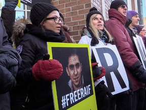Supporters of Raif Badawi, including Badawi's wife, Ensaf Haidar, left, demonstrated outside Complexe Desjardins in Montreal, on Tuesday, January 13, 2015 for the release of Badawi, a blogger who was convicted last May of insulting Islam in his blog, and sentenced to 10 years in prison and 1,000 lashes.
