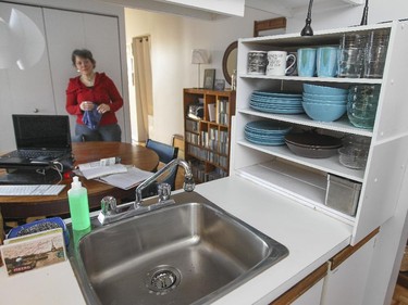 Dishes are stored in adapted IKEA shelves in the kitchen.