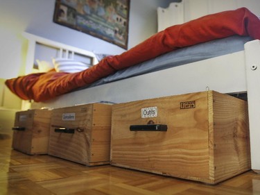 SAQ wine crates with felt sliders under them serve as storage under Alison Lush's bed.