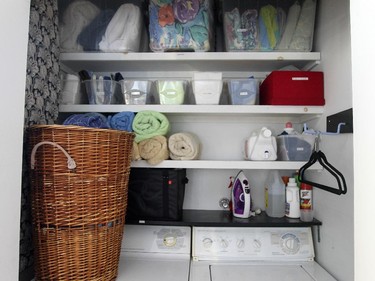 Shelves with bins organize the laundry closet in the dining room.