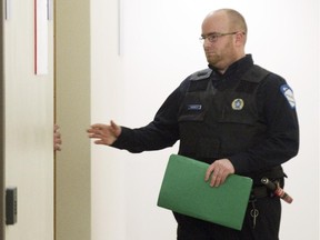 Montreal police constable Mathieu Brassard enters a room for a coroner's inquest at the Gouin courthouse in Montreal, Jan. 16, 2015, into the death of Alain Magloire who was shot by Brassard on February 3, 2014.