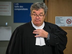 Normand Bibeau, lawyer for Montreal police sergeant André Thibodeau, leaves a courtroom after a hearing for his client at the Laval courthouse on Friday, Jan. 16, 2015.