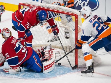 Montreal Canadiens goalie Dustin Tokarski is scored on by New York Islanders centre John Tavares, not pictured, as Canadiens defenceman P.K. Subban, top, attempts to knock out the puck during the third period at the Bell Centre on Saturday, Jan. 17.