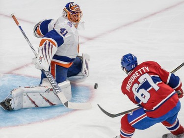 Montreal Canadiens left wing Max Paciorett makes a shot against New York Islanders goalie Jaroslav Halak during the first period at the Bell Centre on Saturday, Jan. 17.