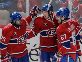 Montreal Canadiens right wing Dale Weise, centre, celebrates his goal with teammates P.K. Subban, left, and Max Pacioretty during the second period at the Bell Centre on Saturday, Jan. 17.