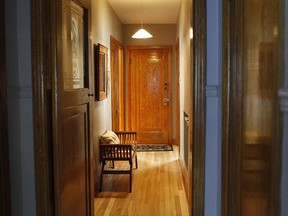 The hallway is nicely decorated with oak trim around the doors, hardwood floors, etched glass at Hélène's and Richard's house, a retired travel agent and an engineer. Their home - the middle apartment of a triplex - is elegantly furnished.