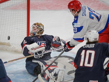 Team Russia forward Alexander Sharov, right, scores a goal against Team USA goalie Thatcher Demko, left, as Team USA forward Anthony Louis, bottom right, looks on during the first period of their 2015 IIHF World Junior Championship quarterfinal hockey match at the Bell Centre Friday, January 2, 2015.