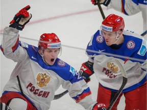 Russian forward Ivan Barbashev, left, celebrates his goal against Team USA with teammate Rushan Rafikov during the first period of World Junior Hockey Championship quarterfinal game at the Bell Centre in Montreal on Jan. 2, 2015.
