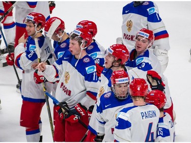 Team Russia players celebrate after beating Team USA in their 2015 IIHF World Junior Championship quarterfinal hockey match.