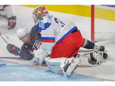 Team USA forward Miles Wood, left, collides with the net and Team Russia goalie Igor Shestyorkin, right, during the third period of their 2015 IIHF World Junior Championship quarterfinal hockey match.