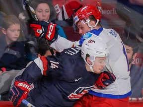 Team USA forward Tyler Motte collides with Russia's Alexander Bryntsev, during World Junior Hockey Championship quarterfinal game at the Bell Centre on Jan. 2, 2014.