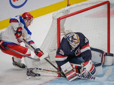 Team USA goalie Thatcher Demko, right, makes a save against Team Russia forward Anatoli Golyshev, left, during the first period of their 2015 IIHF World Junior Championship quarterfinal hockey match at the Bell Centre in Montreal on Friday, January 2, 2015.