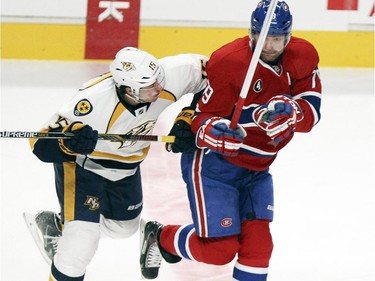 Montreal Canadiens Andrei Markov, right, sidesteps a check by Nashville Predators  Craig Smith during first pleriod of National Hockey League game in Montreal Tuesday January 20, 2015.
