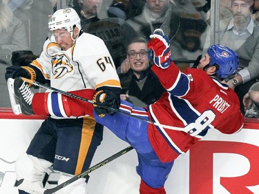 Montreal Canadiens Brandon Prust is knocked off balance by Nashville Predators Victor Bartley  during first period of National Hockey League game in Montreal Tuesday January 20, 2015.