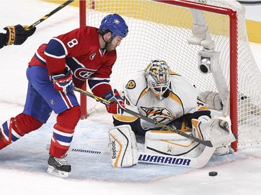Montreal Canadiens Brandon Prust tries to control rebound in front of Nashville Predators goalie Carter Hutton during second period of National Hockey League game in Montreal Tuesday January 20, 2015.