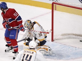 Montreal Canadiens David Desharnais screens Nashville Predators goalie Carter Hutton as Canadiens P.K. Subban's shot finds the back of the net for the game winner during overtime of National Hockey League game in Montreal Tuesday January 20, 2015.  Predators Mattias Ekholm is in the foreground.