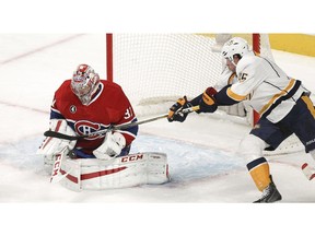 Montreal Canadiens goalie Carey Price makes a save as Nashville Predators Craig Smith reaches for the rebound during first period of National Hockey League game in Montreal Tuesday January 20, 2015.