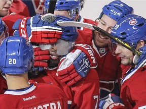 Montreal Canadiens P.K. Subban, centre, is mobbed by teammates after scoring the winning against the Nashville Predators during overtime of National Hockey League game in Montreal Tuesday January 20, 2015.