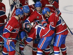 The Canadiens' P.K. Subban is mobbed by teammates after scoring the winning goal in overtime against the Nashville Predators at the Bell Centre on Jan. 20, 2015.