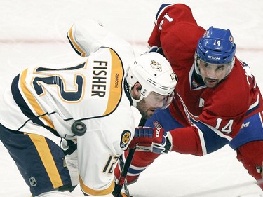 Montreal Canadiens Tomas Plekanec watches the puck as Nashville Predators Mike Fisher wins face-off during first period of National Hockey League game in Montreal Tuesday January 20, 2015.